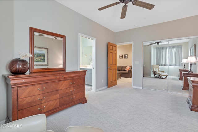 carpeted bedroom with multiple windows, ensuite bathroom, a closet, and ceiling fan