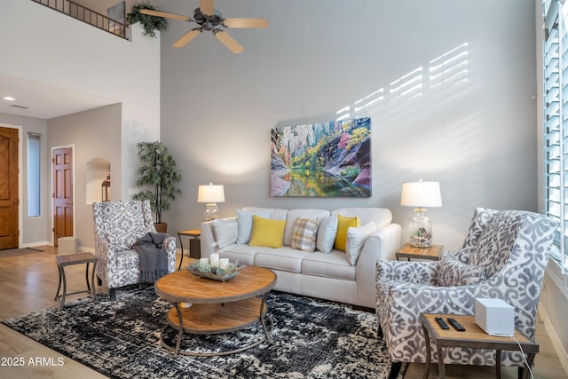 living room with ceiling fan and wood-type flooring