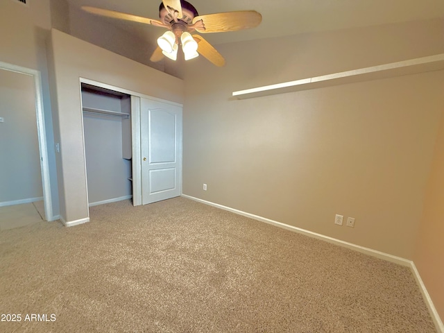 unfurnished bedroom featuring carpet, baseboards, a closet, and ceiling fan