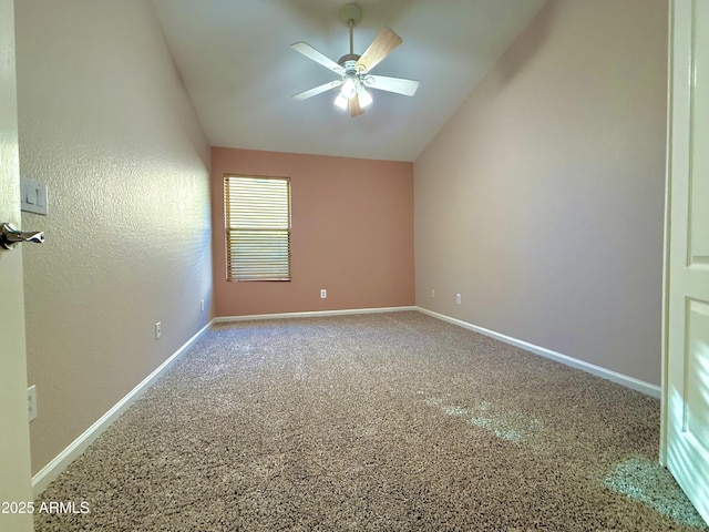 spare room featuring ceiling fan, baseboards, and vaulted ceiling