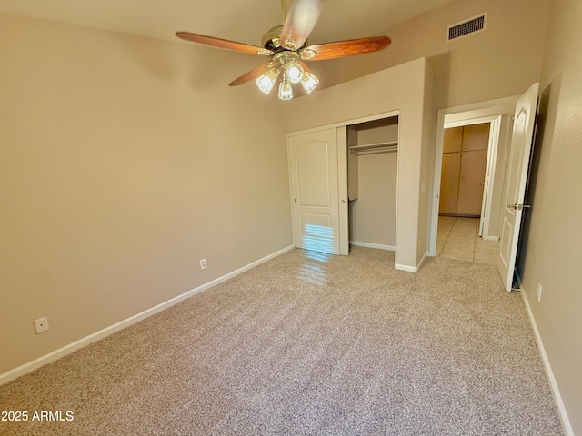 unfurnished bedroom with visible vents, a ceiling fan, a closet, baseboards, and light colored carpet