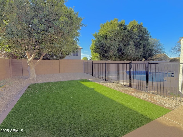 view of yard with a fenced in pool and a fenced backyard