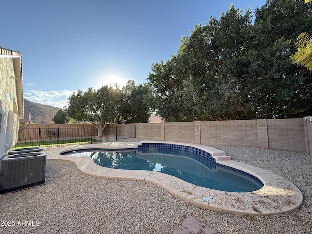 view of pool featuring central air condition unit, a fenced in pool, and a fenced backyard