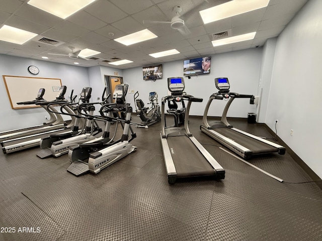 exercise room with baseboards, visible vents, a drop ceiling, and ceiling fan