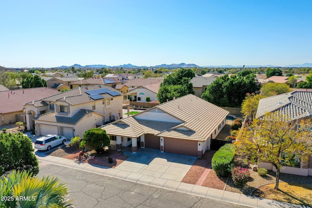 birds eye view of property with a mountain view and a residential view