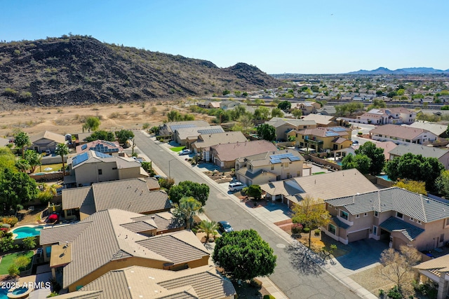 drone / aerial view featuring a residential view and a mountain view