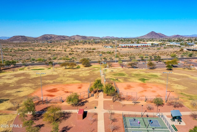 drone / aerial view featuring a mountain view and view of desert