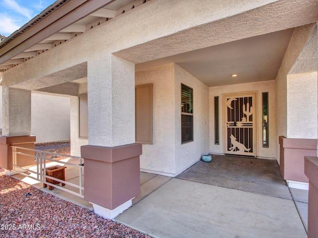 view of exterior entry featuring stucco siding