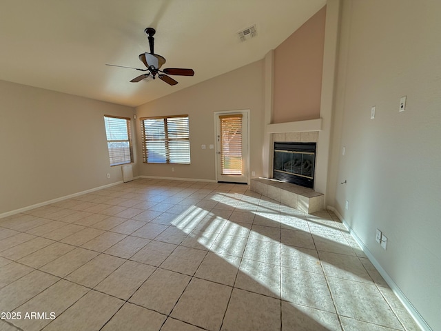 unfurnished living room with visible vents, a ceiling fan, a tiled fireplace, light tile patterned flooring, and baseboards