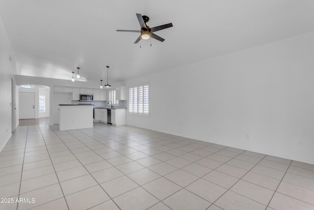 1405 E Chicago Cir, Chandler, AZ 85225 - unfurnished living room featuring a ceiling fan, arched walkways, and light tile patterned floors