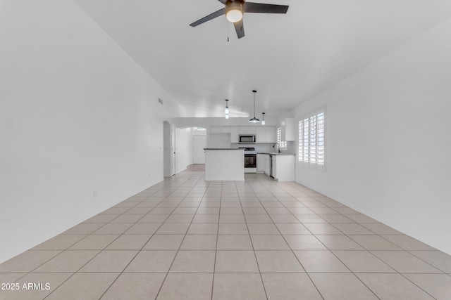 1405 E Chicago Cir, Chandler, AZ 85225 - unfurnished living room featuring ceiling fan, arched walkways, and light tile patterned flooring