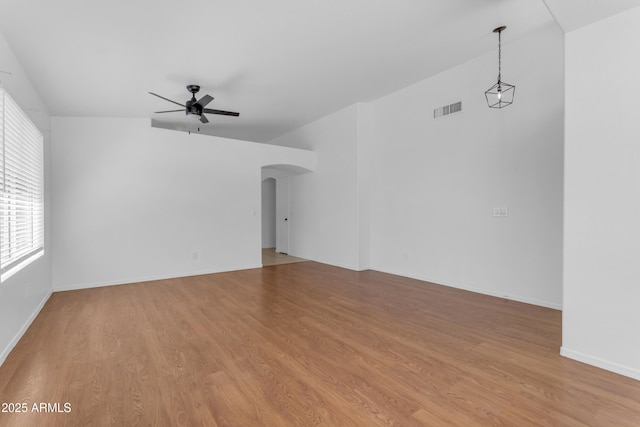 1405 E Chicago Cir, Chandler, AZ 85225 - empty room with ceiling fan, arched walkways, and light wood finished floors