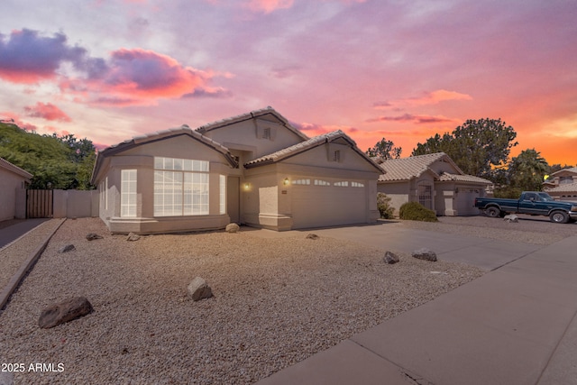 1405 E Chicago Cir, Chandler, AZ 85225 - view of front of house with a garage, driveway, a tiled roof, and stucco siding