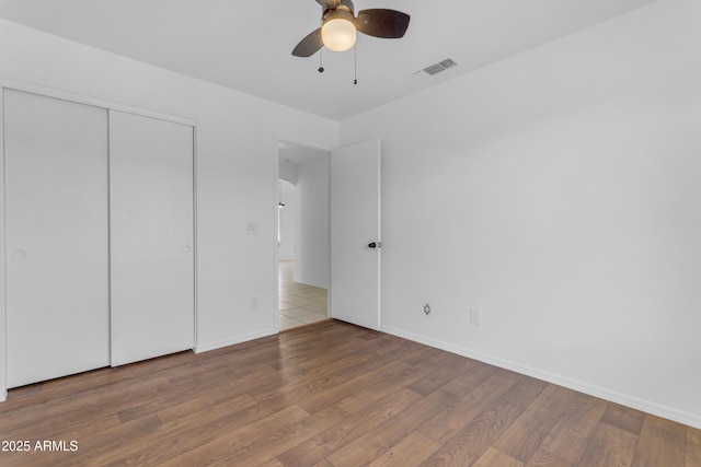 1405 E Chicago Cir, Chandler, AZ 85225 - unfurnished bedroom featuring wood finished floors, a closet, and a ceiling fan