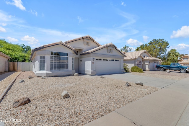 1405 E Chicago Cir, Chandler, AZ 85225 - view of front of house with an attached garage, driveway, a gate, stucco siding, and a tile roof