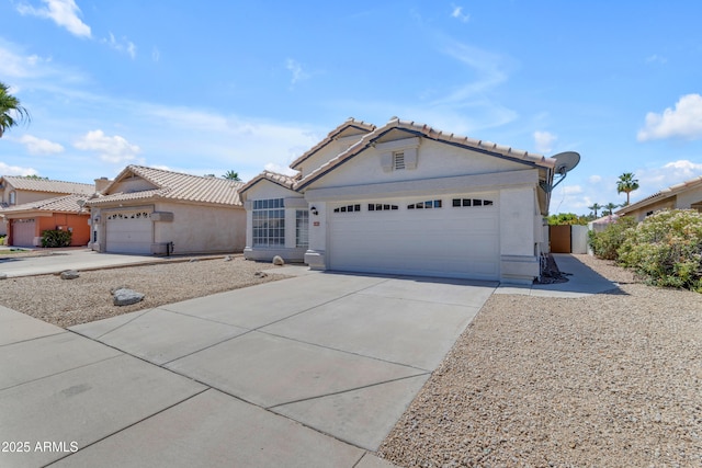 1405 E Chicago Cir, Chandler, AZ 85225 - ranch-style house featuring an attached garage, a tile roof, driveway, and stucco siding