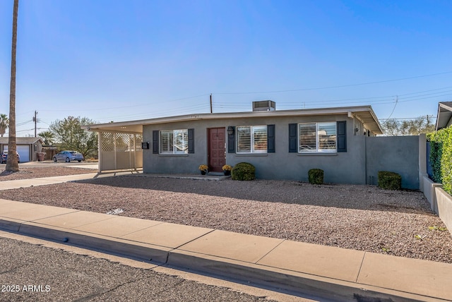 7743 E Roosevelt St, Scottsdale, AZ 85257 - ranch-style home with a carport, fence, driveway, and stucco siding