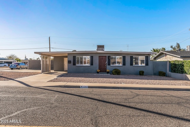 ranch-style home featuring a carport