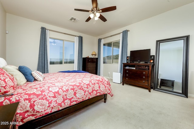 bedroom with access to outside, multiple windows, light colored carpet, and visible vents