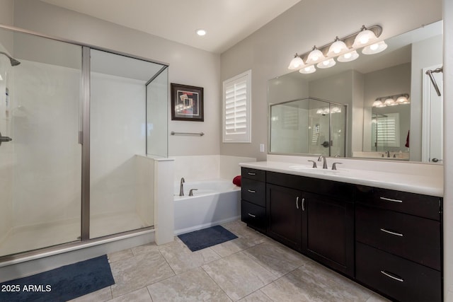 bathroom with tile patterned floors, a stall shower, vanity, and a garden tub