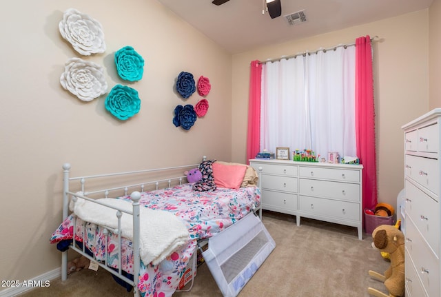 carpeted bedroom featuring a ceiling fan, visible vents, and baseboards