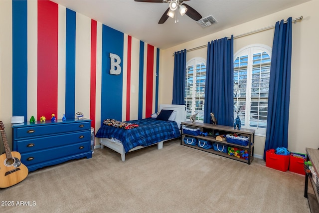 carpeted bedroom featuring visible vents and a ceiling fan