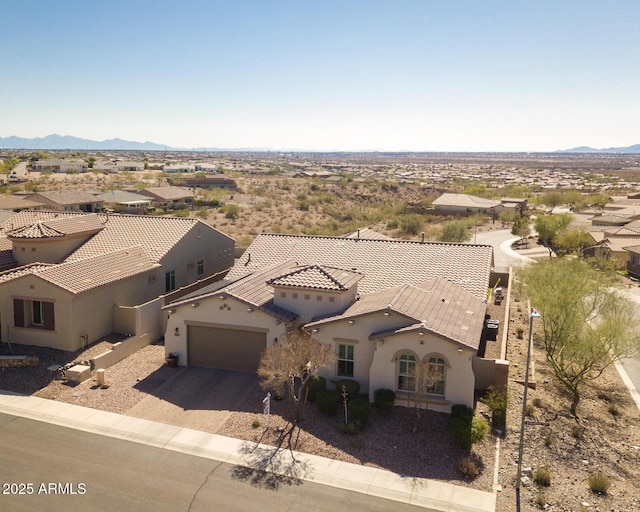 birds eye view of property with a mountain view