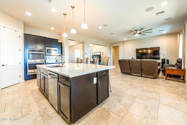 kitchen featuring visible vents, a sink, recessed lighting, appliances with stainless steel finishes, and hanging light fixtures