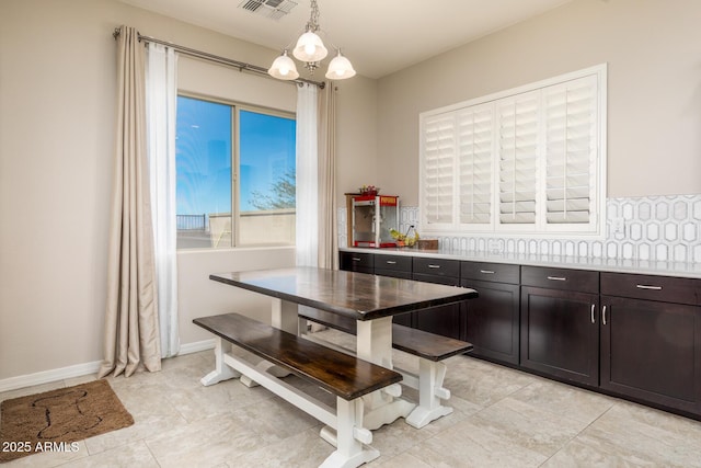 dining space featuring visible vents and baseboards