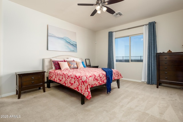 bedroom featuring a ceiling fan, light colored carpet, visible vents, and baseboards