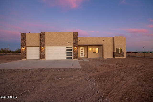 29785 N 203rd Dr, Wittmann, AZ 85361 - view of front of property with driveway, a garage, and stucco siding