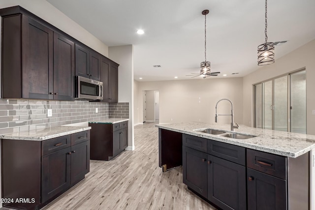 29785 N 203rd Dr, Wittmann, AZ 85361 - kitchen featuring a sink, stainless steel microwave, recessed lighting, decorative backsplash, and ceiling fan