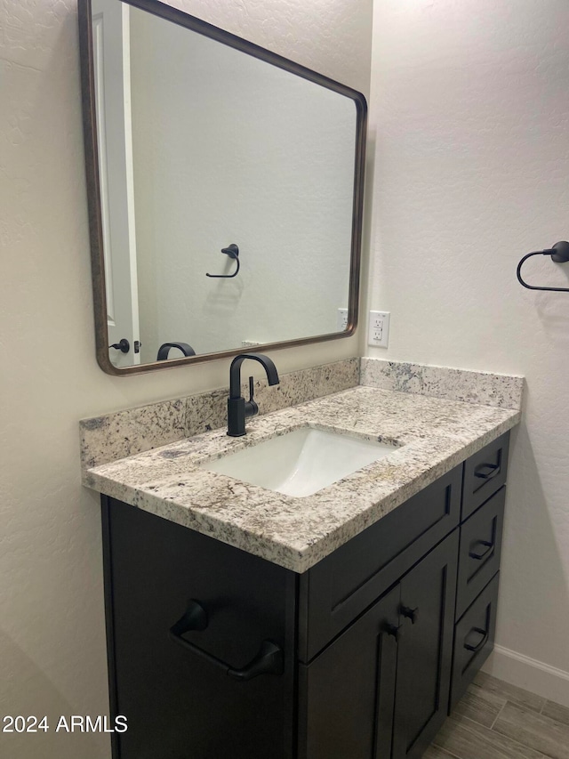 bathroom featuring vanity and hardwood / wood-style floors