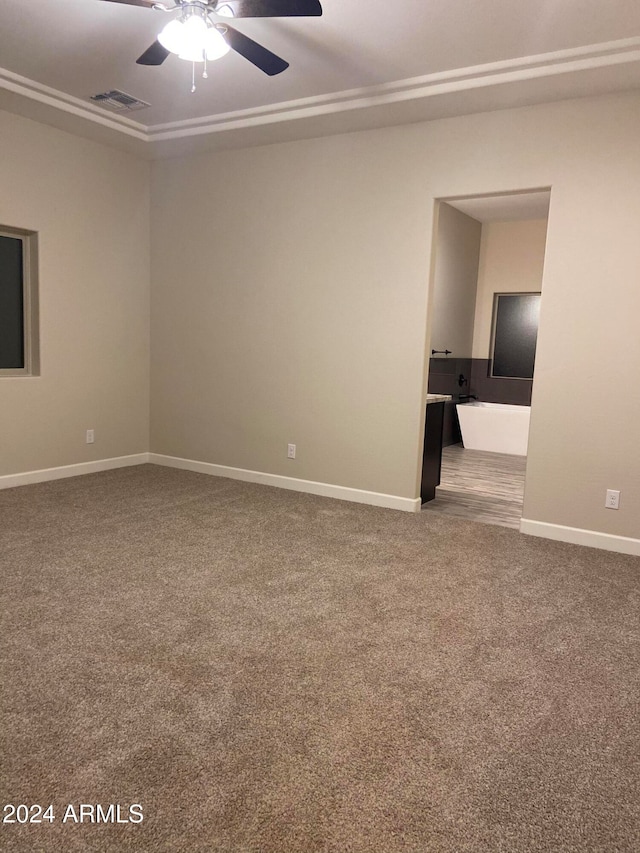 empty room featuring carpet flooring and ceiling fan