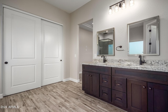 29785 N 203rd Dr, Wittmann, AZ 85361 - bathroom featuring wood finished floors, a shower, baseboards, and double vanity