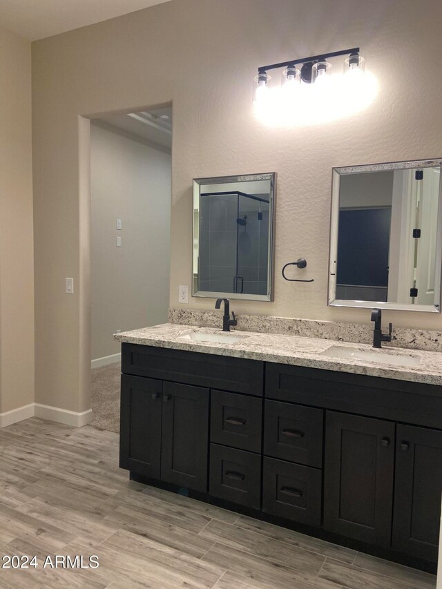 bathroom with vanity and wood-type flooring