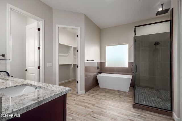 29785 N 203rd Dr, Wittmann, AZ 85361 - bathroom with a shower stall, a freestanding bath, vanity, wood finished floors, and a spacious closet