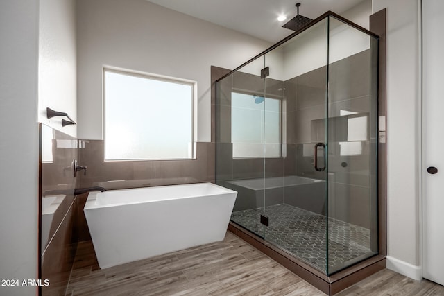 bathroom featuring hardwood / wood-style floors and plus walk in shower