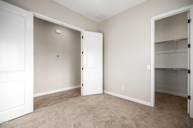 29785 N 203rd Dr, Wittmann, AZ 85361 - unfurnished bedroom with carpet floors, a spacious closet, baseboards, and a closet