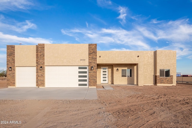 29785 N 203rd Dr, Wittmann, AZ 85361 - adobe home with driveway, an attached garage, and stucco siding