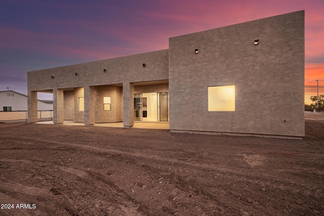 29785 N 203rd Dr, Wittmann, AZ 85361 - back of house at dusk with a patio area and stucco siding