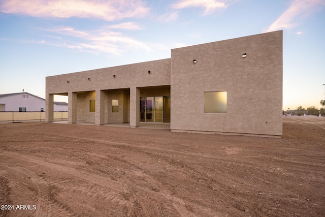 view of back house at dusk