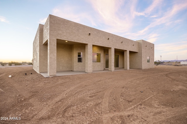 view of back house at dusk