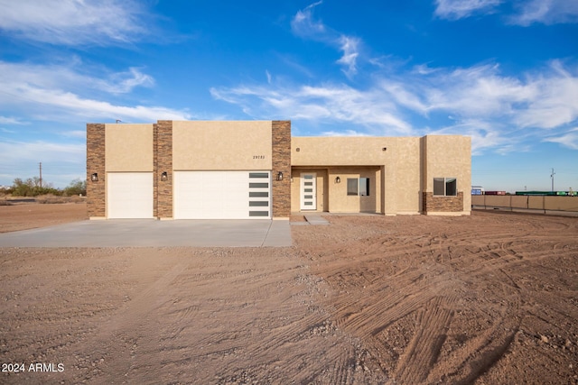 29785 N 203rd Dr, Wittmann, AZ 85361 - view of front of house with dirt driveway, stucco siding, a garage, and fence
