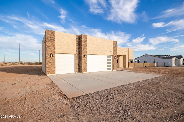 29785 N 203rd Dr, Wittmann, AZ 85361 - view of front of house featuring an attached garage, concrete driveway, and stucco siding