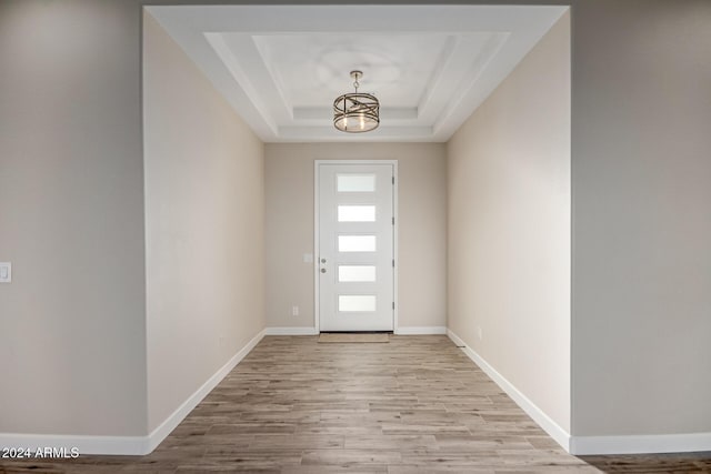 29785 N 203rd Dr, Wittmann, AZ 85361 - doorway to outside with a chandelier, wood finished floors, a raised ceiling, and baseboards