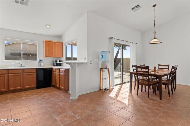 kitchen featuring sink, hanging light fixtures, vaulted ceiling, light tile patterned floors, and black dishwasher