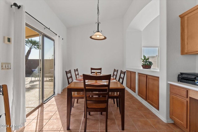 dining area featuring light tile patterned flooring and lofted ceiling