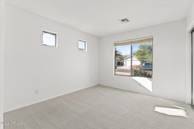 unfurnished room with light carpet