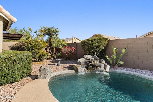 view of swimming pool with pool water feature